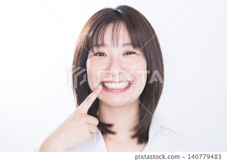 A young woman with beautiful white teeth and a smile. 140779483