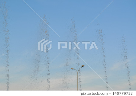 fountain water stream jets in a row on a sunny day fountain water stream jets in a row on a sunny day 140779732