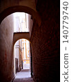 alley in the old town in Warsaw, gate between tenement houses 140779740