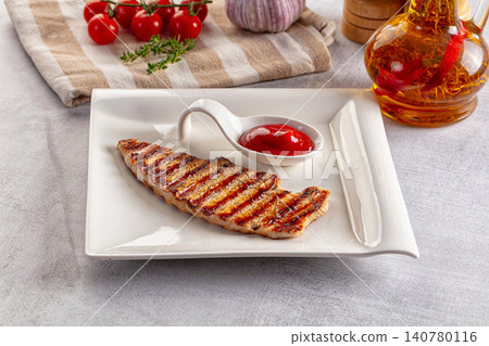 Grilled turkey steak with ketchup on white plate Grilled turkey steak with ketchup on white plate 140780116