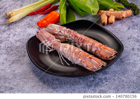 Fresh mantis shrimp on black plate with lemongrass chili and herbs 140780156