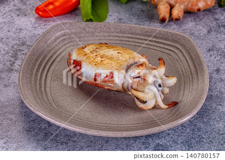 Grilled cuttlefish on ceramic plate with red pepper and turmeric Grilled cuttlefish on ceramic plate with red pepper and turmeric 140780157