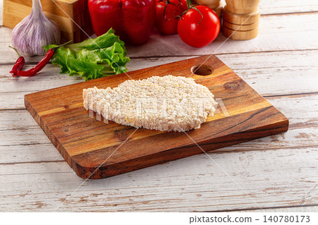 Breaded chicken cutlet on wooden cutting board with fresh vegetables Breaded chicken cutlet on wooden cutting board with fresh vegetables 140780173