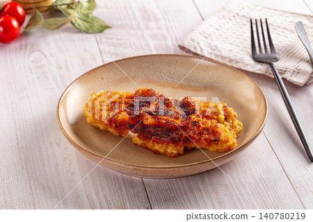 Crispy breaded chicken cutlet on ceramic plate with cherry tomatoes and fork Crispy breaded chicken cutlet on ceramic plate with cherry tomatoes and fork 140780219