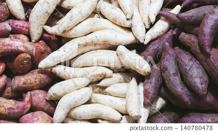 Top view of various types of sweet potatoes, colorful assortment of raw purple, white and red sweet potato tubers background. Top view of various types of sweet potatoes, colorful assortment of raw purple, white and red sweet potato tubers background. 140780478