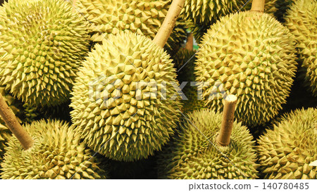 Close-up of fresh durian fruits pile, full frame background of ripe tropical king of fruits with sharp thorns. 140780485