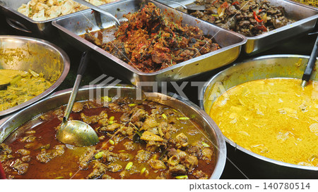 Close-up of ready-to-eat authentic Thai dishes including curry with bitter beans (Sator) and chili catfish. Close-up of ready-to-eat authentic Thai dishes including curry with bitter beans (Sator) and chili catfish. 140780514
