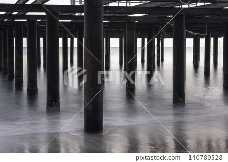 Vintage Beach Pier Extending into the Sea. Vintage Beach Pier Extending into the Sea. 140780528