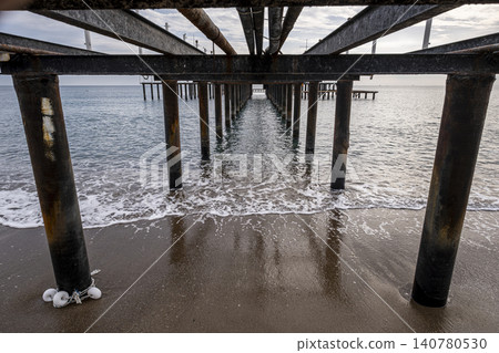 Vintage Beach Pier Extending into the Sea. Vintage Beach Pier Extending into the Sea. 140780530