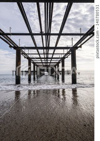 Vintage Beach Pier Extending into the Sea. Vintage Beach Pier Extending into the Sea. 140780531
