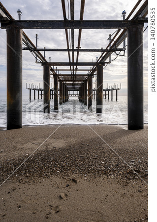 Vintage Beach Pier Extending into the Sea. Vintage Beach Pier Extending into the Sea. 140780535