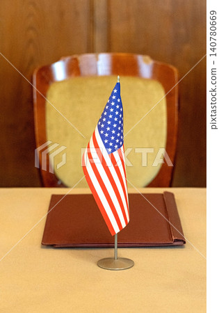 United states flag on desk representing government decisions United states flag on desk representing government decisions 140780669