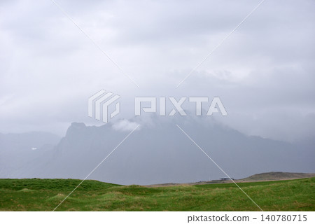 Misty mountain peaks shrouded in thick clouds, Iceland 140780715