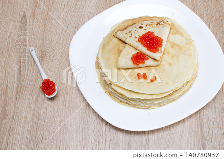 Pancakes with red caviar. Pancakes with caviar on a white plate. Pancakes with red caviar on a plate and a wooden board. Pancakes with red caviar. Pancakes with caviar on a white plate. Pancakes with red caviar on a plate and a wooden board. 140780937