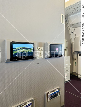In-flight display in the front row of economy class on an airplane (vertical composition) | Travel and aviation related articles, websites, and materials In-flight display in the front row of economy class on an airplane (vertical composition) | Travel and aviation related articles, websites, and materials 140781323