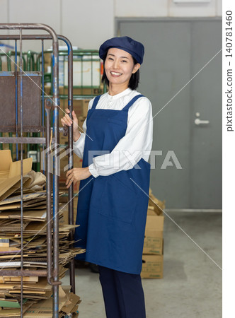 A female staff member in her 40s who manages inventory. A female staff member in her 40s who manages inventory. 140781460