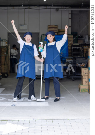 Two female staff members in their 40s performing cleaning work. Two female staff members in their 40s performing cleaning work. 140781532