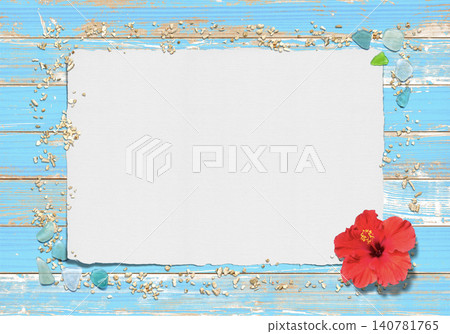 A blue wooden deck, coral sand and beach glass, and a paper frame depicting a blooming summer flower. A blue wooden deck, coral sand and beach glass, and a paper frame depicting a blooming summer flower. 140781765