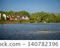A modern housing development next to the Holmethorpe Lagoons in Mersham, Surrey, UK. Ducks are on a small island in the foreground. 140782396