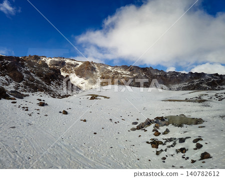 Snow Covered Volcanic Mountain Landscape Under Blue Sky Snow Covered Volcanic Mountain Landscape Under Blue Sky 140782612