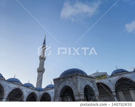 Mosque minaret and domes under blue sky Mosque minaret and domes under blue sky 140782650
