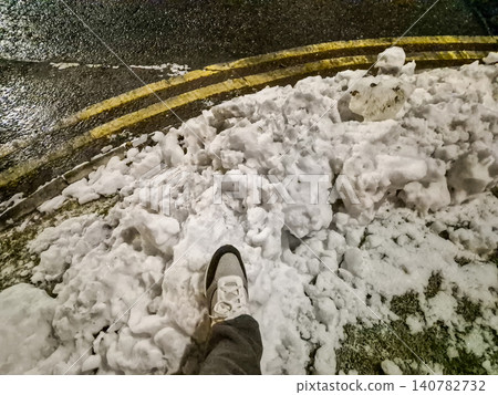 Walking through heavy snow beside a wet road Walking through heavy snow beside a wet road 140782732