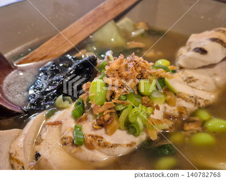 Steaming chicken soup with vegetables and herbs Steaming chicken soup with vegetables and herbs 140782768