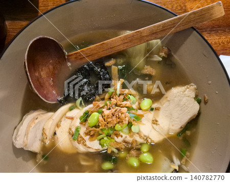 Chicken noodle soup with vegetables and wooden spoon 140782770