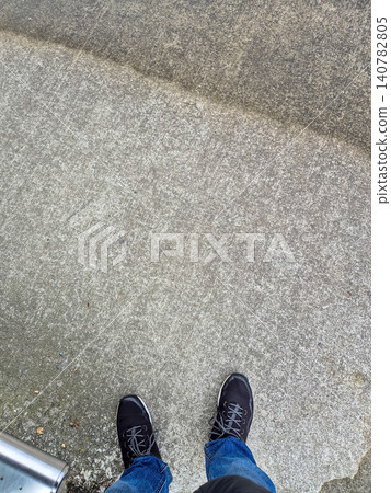 Standing on Concrete Sidewalk with Casual Shoes Standing on Concrete Sidewalk with Casual Shoes 140782805