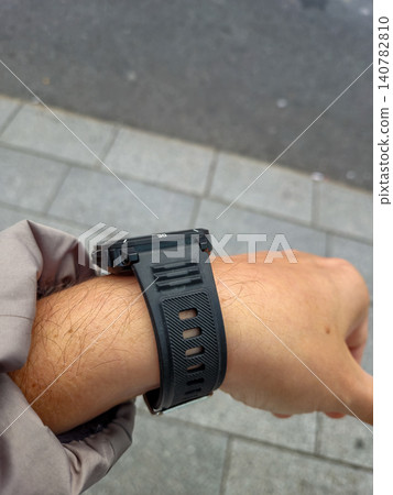 Close Up of Wrist Wearing a Smartwatch Outdoors Close Up of Wrist Wearing a Smartwatch Outdoors 140782810