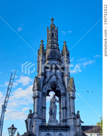 Gothic monument with statues against blue sky Gothic monument with statues against blue sky 140782812