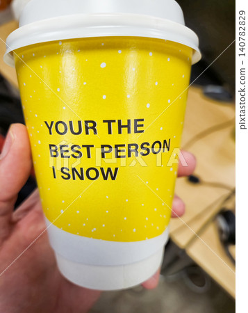 Hand Holding Yellow Paper Coffee Cup With Message 140782829