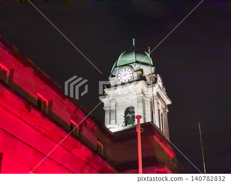 Historic clock tower at night with dramatic lighting Historic clock tower at night with dramatic lighting 140782832
