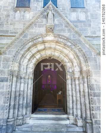 Ornate stone church entrance with arched doorway Ornate stone church entrance with arched doorway 140782868