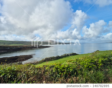 Scenic coastal landscape with calm sea and cloudy sky Scenic coastal landscape with calm sea and cloudy sky 140782895