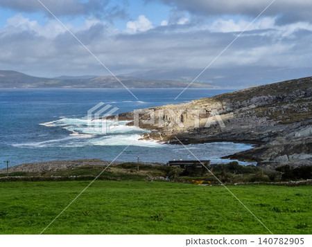 Rocky coastline with ocean waves and cloudy sky Rocky coastline with ocean waves and cloudy sky 140782905