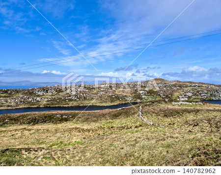 Rugged coastal landscape with rocky hills and blue sky Rugged coastal landscape with rocky hills and blue sky 140782962