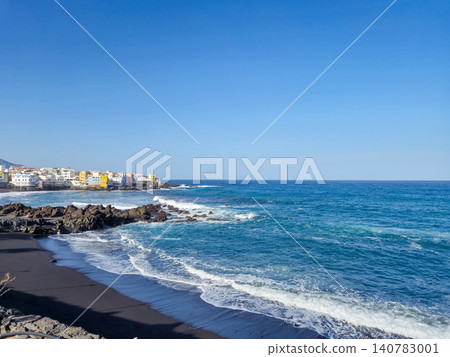 Coastal shoreline with black sand beach and ocean waves 140783001
