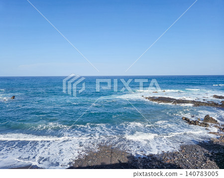 Calm Blue Ocean Waves Against Rocky Shoreline Calm Blue Ocean Waves Against Rocky Shoreline 140783005