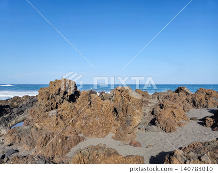 Rocky Seashore Under Clear Blue Sky Rocky Seashore Under Clear Blue Sky 140783010