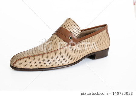 Beige woven leather mens loafer isolated on white background Beige woven leather mens loafer isolated on white background 140783038
