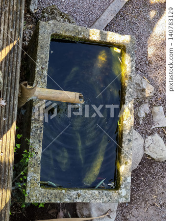 Top view of stone water basin with bamboo spout Top view of stone water basin with bamboo spout 140783129