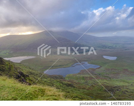 Mountain valley with lakes under dramatic cloudy sky Mountain valley with lakes under dramatic cloudy sky 140783193