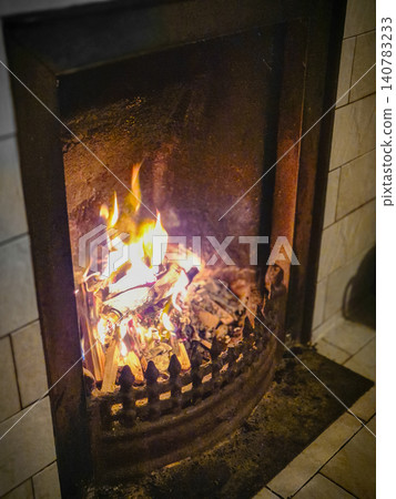 Burning fire in rustic indoor fireplace Burning fire in rustic indoor fireplace 140783233