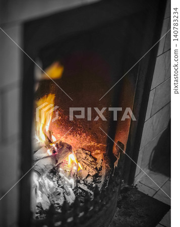 Burning fireplace with glowing flames indoors 140783234