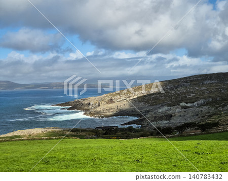 Rocky coastal landscape with green meadow and clouds Rocky coastal landscape with green meadow and clouds 140783432