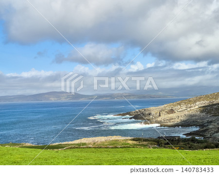 Rocky coastline with blue sea and cloudy sky Rocky coastline with blue sea and cloudy sky 140783433