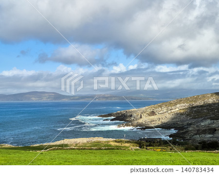 Scenic coastal landscape with rocky cliffs and cloudy sky Scenic coastal landscape with rocky cliffs and cloudy sky 140783434