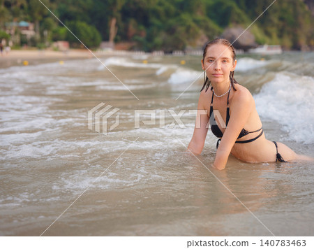 Young woman enjoying serene evening at sea in Krabi, Thailand Young woman enjoying serene evening at sea in Krabi, Thailand 140783463