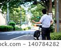 A Japanese businessman, whose face is obscured and whose back is not visible, calls a taxi using a smartphone app for transportation. 140784282